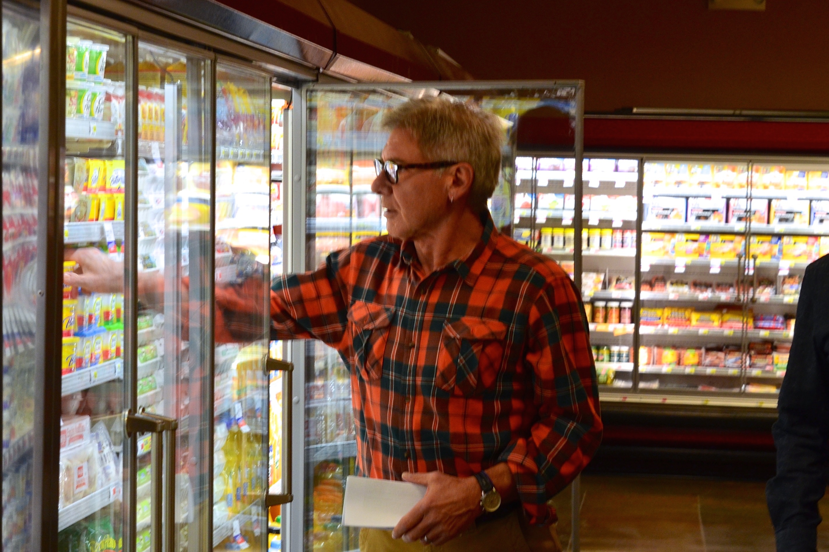 Actor/Conservationist Harrison Ford doing a bit of field research in a local supermarket. (Scene taken from the Showtime Emmy Award wining climate change series “Years of Living Dangerously”. Photograph courtesy of Jeff Horowitz